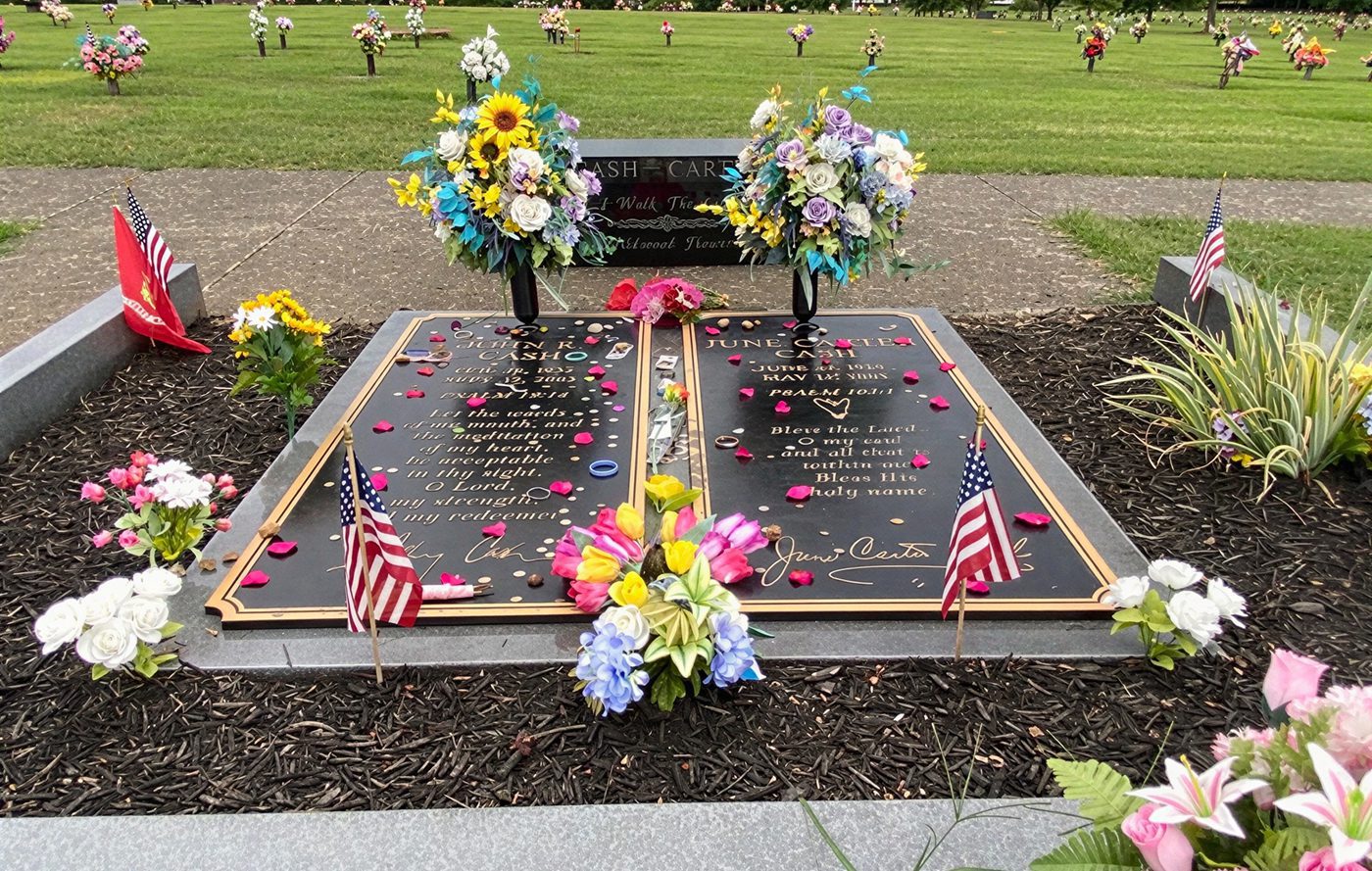 Double headstone with vibrant floral arrangements