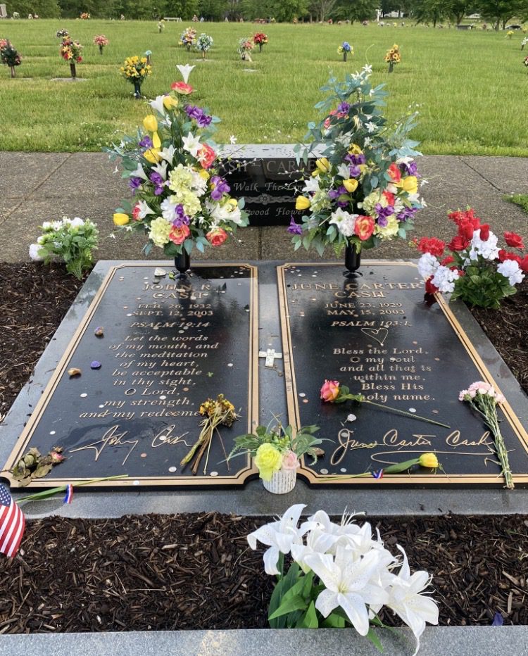 Floral-decorated gravesite with inscriptions